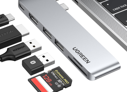 Hub UGREEN CM380 conectado a laptop mostrando puertos USB 3.0 activos